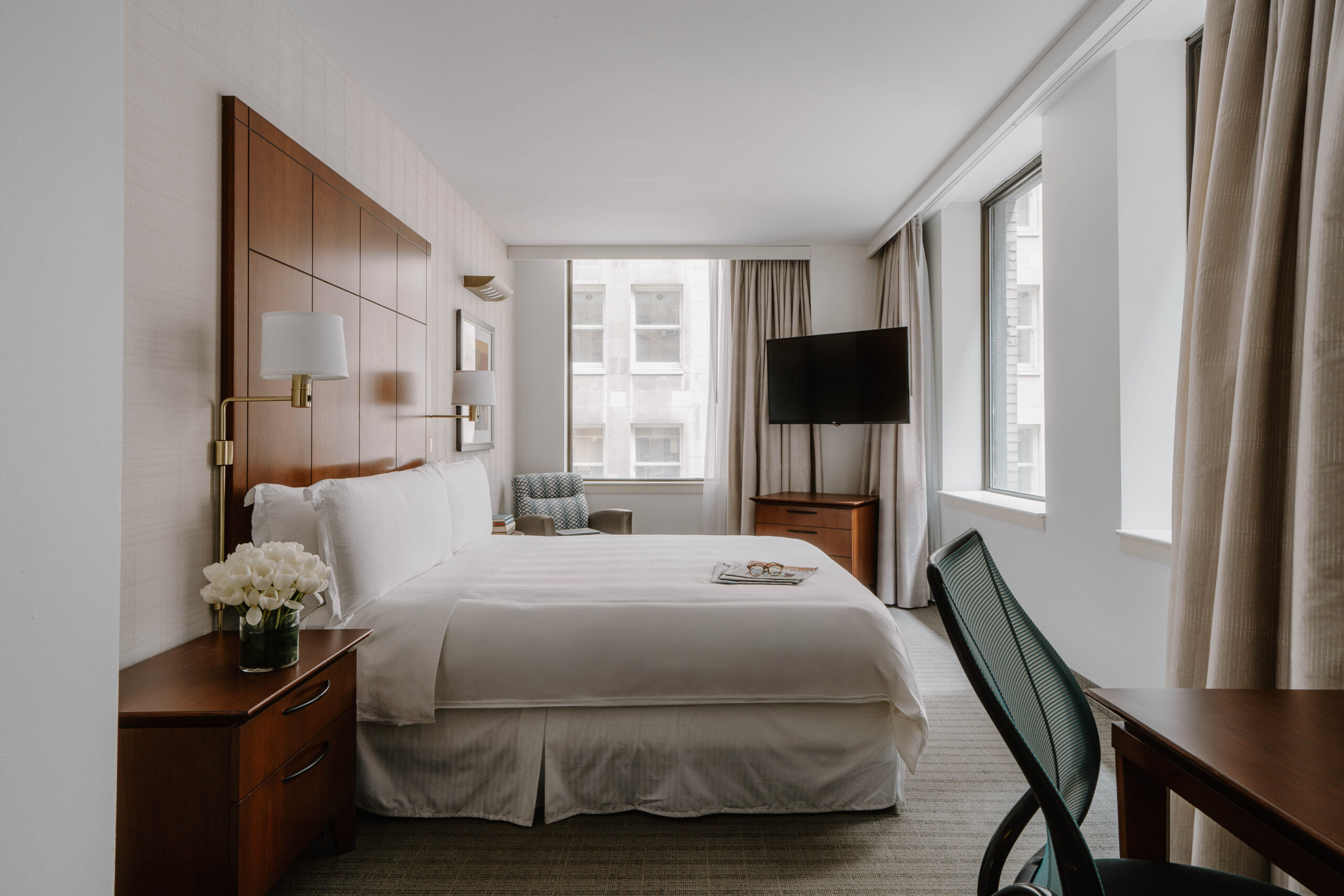 Standard room with king bed, work desk and large windows at Central Loop Hotel