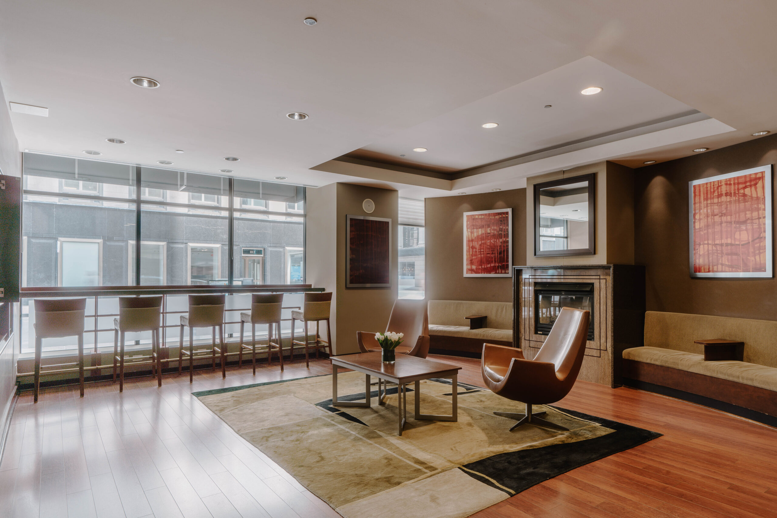 Central Loop Hotel lounge with fireplace, armchairs and window bar seating